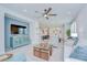 Open-concept living room with light blue accents, ceiling fan and lots of natural light at 3765 Maxwell Park Dr, Sun City Center, FL 33573