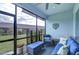 Screened patio featuring comfortable blue outdoor furniture, a ceiling fan, and views of the backyard at 3765 Maxwell Park Dr, Sun City Center, FL 33573