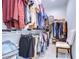 Walk-in closet with shelves and racks, with enough space for clothing and accessories at 3765 Maxwell Park Dr, Sun City Center, FL 33573