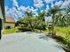 Spacious backyard featuring lush landscaping including palm trees and lawn at 3944 102Nd N Pl, Clearwater, FL 33762