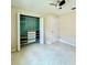 This bedroom features tile floors, a ceiling fan, and a closet with organizers at 3944 102Nd N Pl, Clearwater, FL 33762