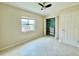 This bedroom features tile floors, a ceiling fan, a window, and a closet with organizers at 3944 102Nd N Pl, Clearwater, FL 33762