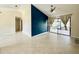 Bright living room featuring tile flooring, sliding glass doors to porch, blue accent wall and vaulted ceilings at 3944 102Nd N Pl, Clearwater, FL 33762