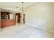 Bright, open-concept living room featuring tile flooring and an adjacent kitchen area at 3944 102Nd N Pl, Clearwater, FL 33762
