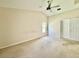 Main bedroom features a ceiling fan, vaulted ceiling and natural light from window and a double door closet at 3944 102Nd N Pl, Clearwater, FL 33762