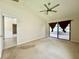 Main bedroom with neutral walls, vaulted ceiling and a ceiling fan that provides access to a screened porch at 3944 102Nd N Pl, Clearwater, FL 33762