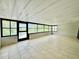 This sunroom features tile floors, white walls, and many windows at 3944 102Nd N Pl, Clearwater, FL 33762