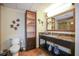 Well-appointed bathroom with granite countertop, decorative mirror, and modern fixtures at 399 C 2Nd St # 313, Indian Rocks Beach, FL 33785