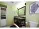 Bathroom with a granite-topped vanity, storage shelves, and sea-themed decor at 399 2Nd St # 313, Indian Rocks Beach, FL 33785