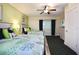 Bedroom with two beds, dark curtains, and a TV providing a comfortable and inviting space at 399 C 2Nd St # 313, Indian Rocks Beach, FL 33785