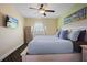 Tranquil bedroom features a ceiling fan, a comfortable bed, and a television for relaxing evenings at 399 C 2Nd St # 313, Indian Rocks Beach, FL 33785