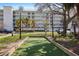 Community bocce ball court nestled amidst tropical palm trees and lush landscaping, offering a relaxing recreational space at 399 C 2Nd St # 313, Indian Rocks Beach, FL 33785