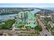 Hotel exterior featuring a waterpark with colorful slides, lazy river, and lush landscaping with palm trees at 399 C 2Nd St # 313, Indian Rocks Beach, FL 33785
