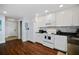 Well-lit kitchen boasting white appliances, ample cabinets, and modern backsplash at 399 C 2Nd St # 313, Indian Rocks Beach, FL 33785