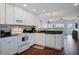 Bright kitchen featuring white cabinetry, modern appliances, and elegant backsplash at 399 C 2Nd St # 313, Indian Rocks Beach, FL 33785