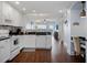 Well-lit kitchen with white cabinets, modern appliances, and dark countertops at 399 C 2Nd St # 313, Indian Rocks Beach, FL 33785