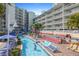 Relaxing lazy river winding through resort with poolside seating and views of the surrounding property at 399 C 2Nd St # 313, Indian Rocks Beach, FL 33785