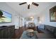 Open-concept living area features a kitchen view, dining set, and comfortable leather sofa at 399 C 2Nd St # 313, Indian Rocks Beach, FL 33785