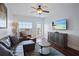 Cozy living room features a ceiling fan, comfortable seating, and a window with a view at 399 C 2Nd St # 313, Indian Rocks Beach, FL 33785