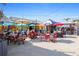 Vibrant outdoor dining area with colorful umbrellas, tables, and chairs, creating an inviting and lively atmosphere at 399 C 2Nd St # 313, Indian Rocks Beach, FL 33785