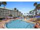 Gathering friendly pool and splashpad at resort near building with views of waterslides and lush palm trees at 399 C 2Nd St # 313, Indian Rocks Beach, FL 33785