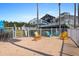 Charming outdoor recreation area with colorful Adirondack chairs, a cornhole game, and views of the surrounding community at 399 C 2Nd St # 313, Indian Rocks Beach, FL 33785