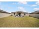 Spacious backyard featuring a well-maintained lawn and patio seating area, perfect for outdoor relaxation at 4025 Capri Coast Dr, Plant City, FL 33565