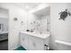 Bright bathroom featuring a double vanity, a large mirror, and a modern fixture, with tiled floors at 4025 Capri Coast Dr, Plant City, FL 33565