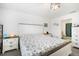 Bright bedroom showcasing white walls, and a stylish white and wood bed frame, with an attached bathroom at 4025 Capri Coast Dr, Plant City, FL 33565