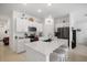 Modern white kitchen featuring a large center island, stainless steel appliances, and ample cabinet space at 4025 Capri Coast Dr, Plant City, FL 33565