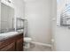 Bathroom with granite vanity, toilet, and window at 4183 Ballantrae Blvd, Land O Lakes, FL 34638