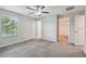 Bedroom with neutral walls, carpet, ceiling fan, access to a bathroom, and a closet at 4183 Ballantrae Blvd, Land O Lakes, FL 34638