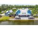 Beautiful blue clubhouse sits beside a picturesque lake at 4183 Ballantrae Blvd, Land O Lakes, FL 34638