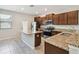 Modern kitchen with stainless steel appliances, granite countertops, and an island, perfect for cooking and entertaining at 4183 Ballantrae Blvd, Land O Lakes, FL 34638