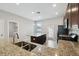 Kitchen island with granite countertops, stainless sink, and wood cabinets, perfect for casual dining and food prep at 4183 Ballantrae Blvd, Land O Lakes, FL 34638