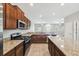 Spacious kitchen with granite countertops, stainless steel appliances, and wood cabinets at 4183 Ballantrae Blvd, Land O Lakes, FL 34638