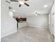 Open-concept space featuring modern tile floors, ceiling fans, with a kitchen view for easy entertaining at 4183 Ballantrae Blvd, Land O Lakes, FL 34638