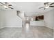 Bright and airy living room featuring tile flooring and ceiling fans throughout the open concept first floor at 4183 Ballantrae Blvd, Land O Lakes, FL 34638