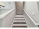 Staircase with wood treads, white risers, and handrail leading upstairs at 4183 Ballantrae Blvd, Land O Lakes, FL 34638