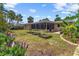 Spacious backyard featuring lush greenery, raised garden beds, and a charming patio area at 4340 50Th S Ter, St Petersburg, FL 33711