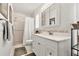 Bright bathroom features a shower, vanity with mirror, and white tile and paint at 4340 50Th S Ter, St Petersburg, FL 33711