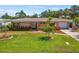 Charming home featuring a well-manicured lawn, brick accents, and lush landscaping at 4340 50Th S Ter, St Petersburg, FL 33711