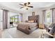 Serene main bedroom featuring soft lighting, plush bedding, and access to an outdoor patio at 4340 50Th S Ter, St Petersburg, FL 33711