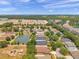 Aerial view of a playground and pond in a neighborhood with many well-maintained homes at 4500 Fieldview Cir, Wesley Chapel, FL 33545
