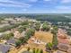 An aerial view showcases a vibrant community with a playground and a serene pond at 4500 Fieldview Cir, Wesley Chapel, FL 33545