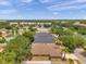 Community aerial view showing houses, trees and water retention pond at 4500 Fieldview Cir, Wesley Chapel, FL 33545