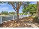 The backyard features a white picket fence, mature trees and view of community playground at 4500 Fieldview Cir, Wesley Chapel, FL 33545
