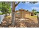 The backyard features partial shade, well-maintained exterior, and simple fence at 4500 Fieldview Cir, Wesley Chapel, FL 33545