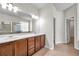 Double vanity bathroom with tiled floors and ample cabinet space plus separate shower and toilet areas at 4500 Fieldview Cir, Wesley Chapel, FL 33545