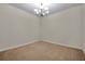 Empty dining room features neutral walls, carpet, and an ornate chandelier at 4500 Fieldview Cir, Wesley Chapel, FL 33545
